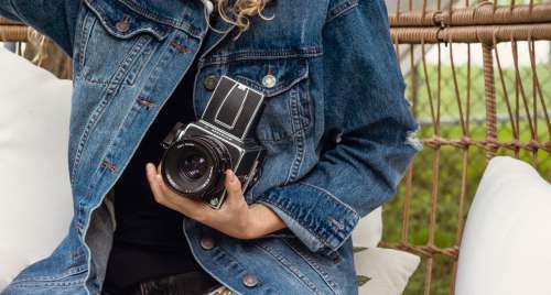 Person Wearing A Jean Jacket And Holding Film Camera Photo