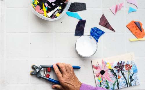 Flatlay Of A Grey Table With A Mosaic And Tools Photo