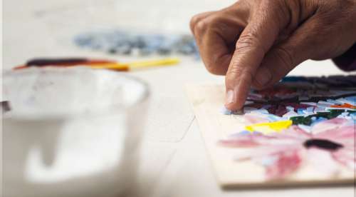 Close Up Of A Persons Hand Adding Glass To A Mosaic Photo