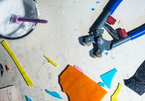 Flatlay Of A Mosaic Artists Tools With Cut Glass Photo