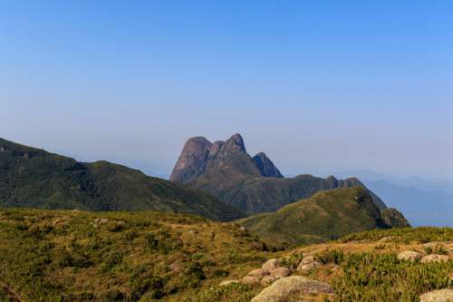 Landscape Of Green Rolling Hills And Mountain Peaks Photo