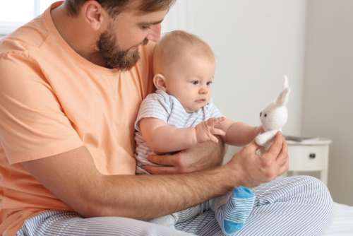 Father with Baby and Bunny Toy Free Stock Photo