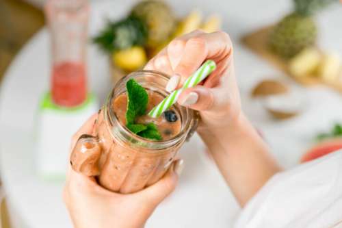 Refreshing Homemade Fruit Smoothie in a Jar with Straw and Mint